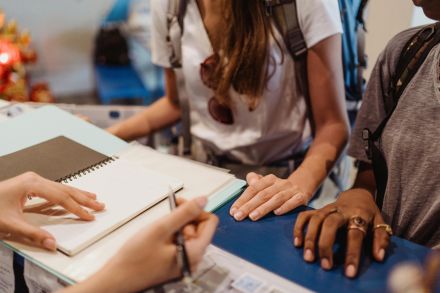 Focus on collaborative learning among diverse students working together at a desk.